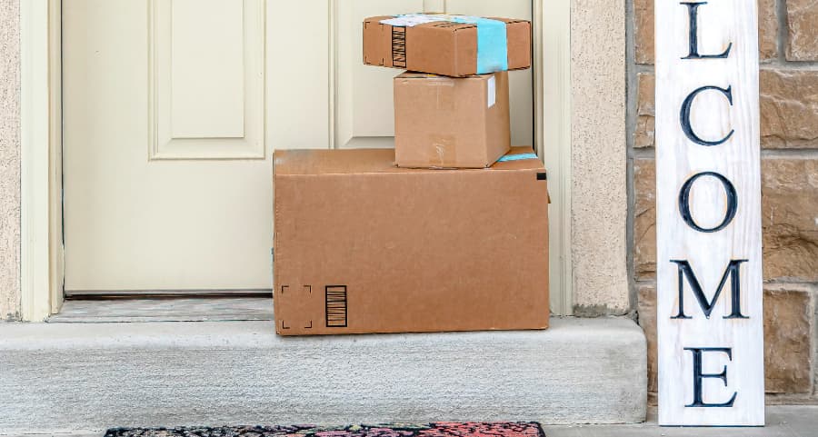 Boxes by the door of a residence with a welcome sign in Scranton